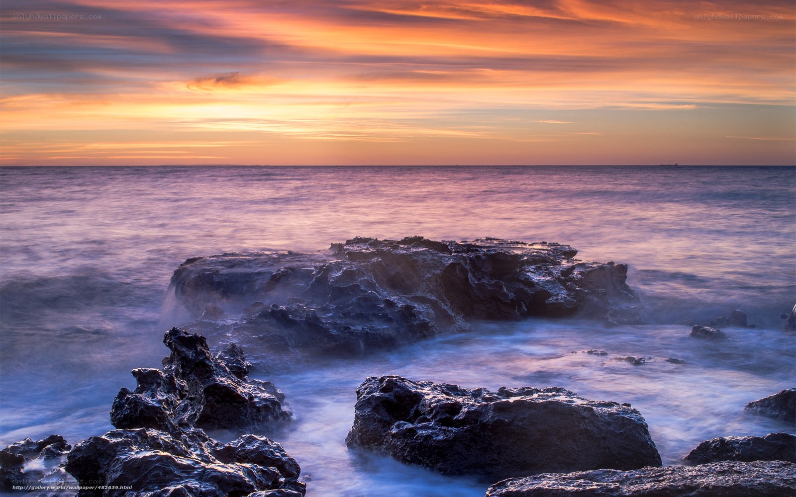 Sunset over rocky coastline