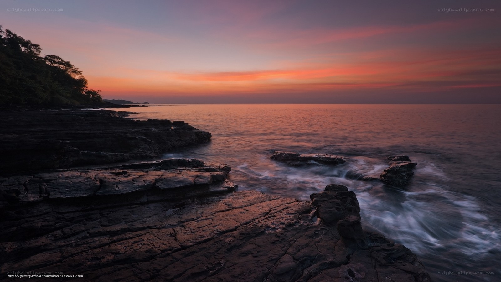 Sunset over rocky coastline