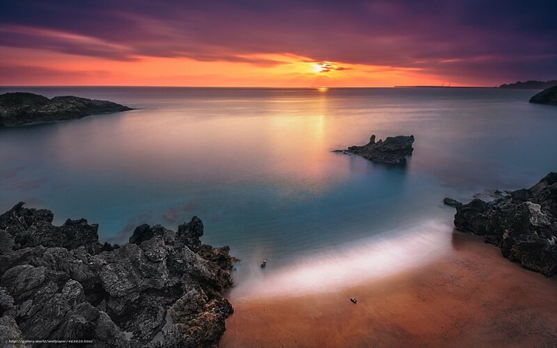 Sunset over rocky coastline