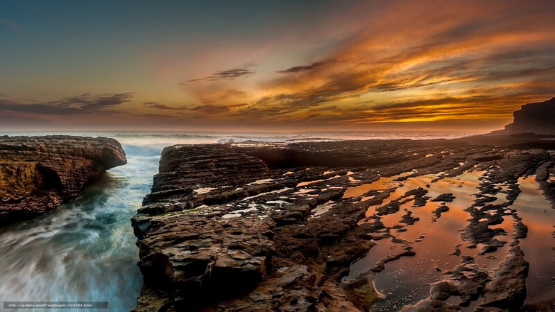 Sunset over rocky coastline