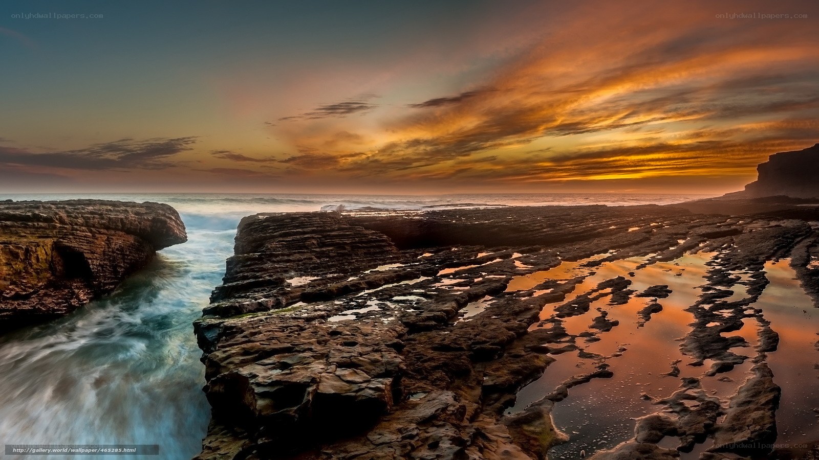 Sunset over rocky coastline