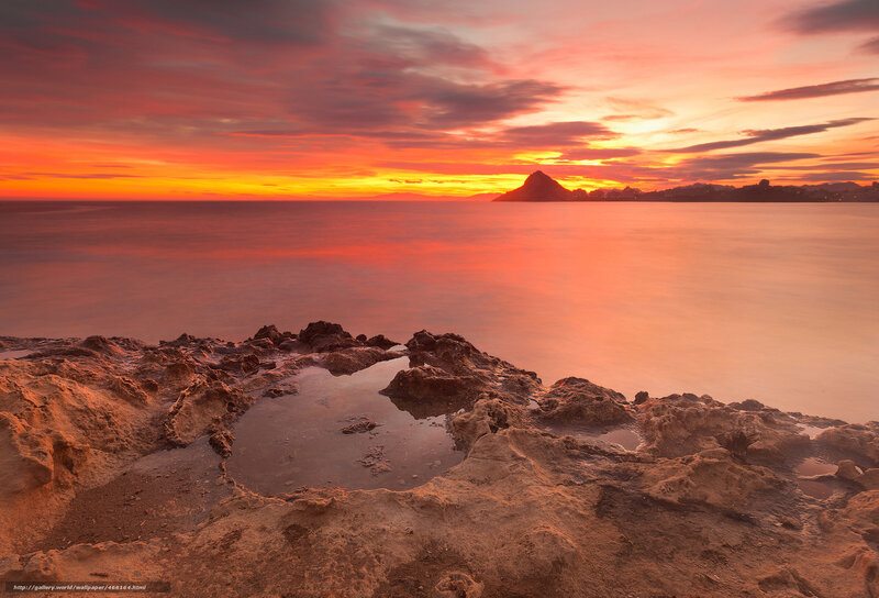 Sunset over rocky coastline
