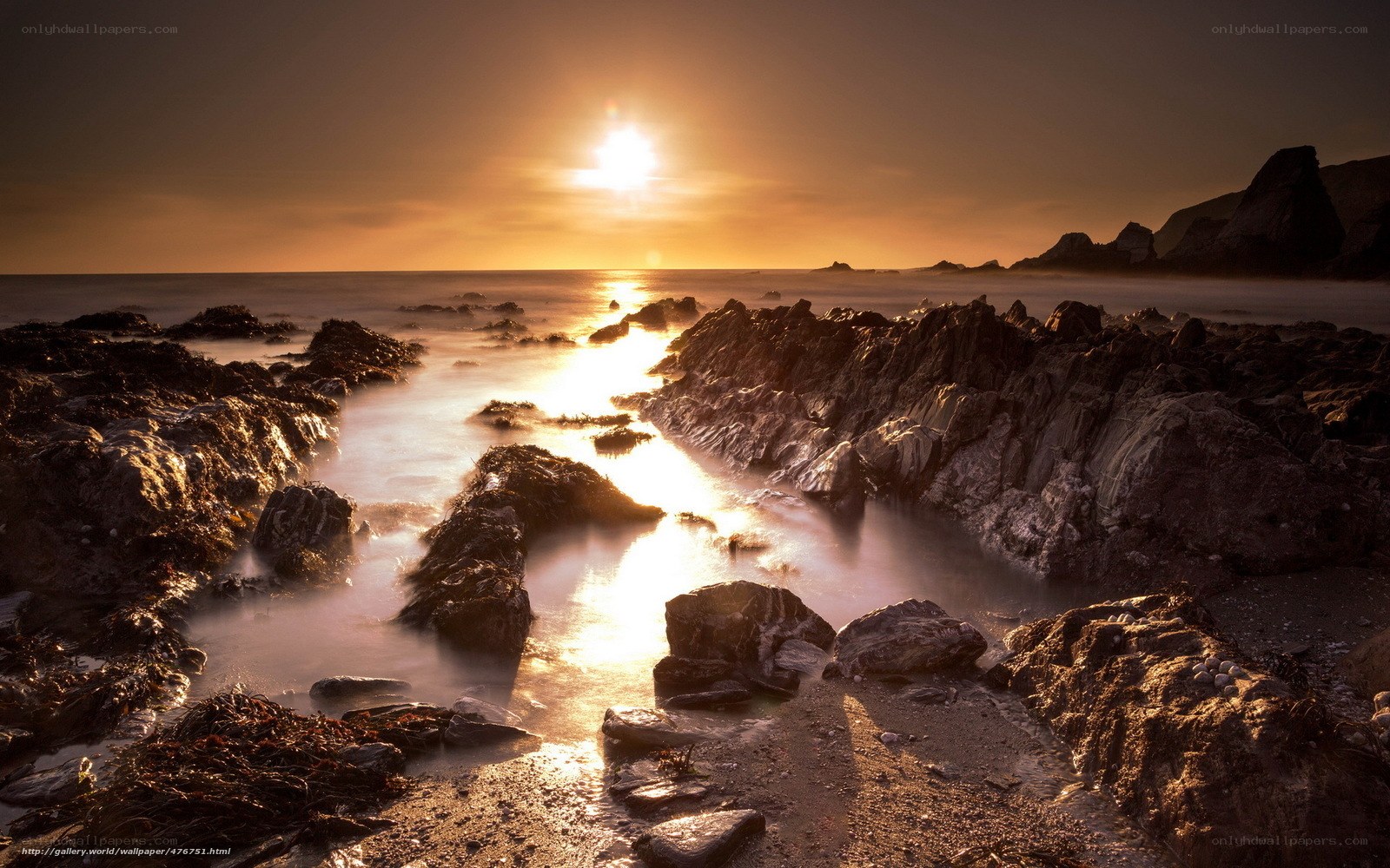 Sunset over rocky coastline