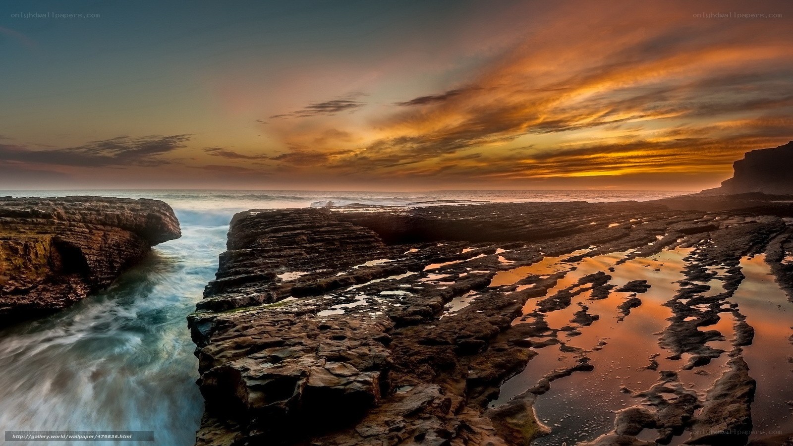 Sunset over rocky coastline