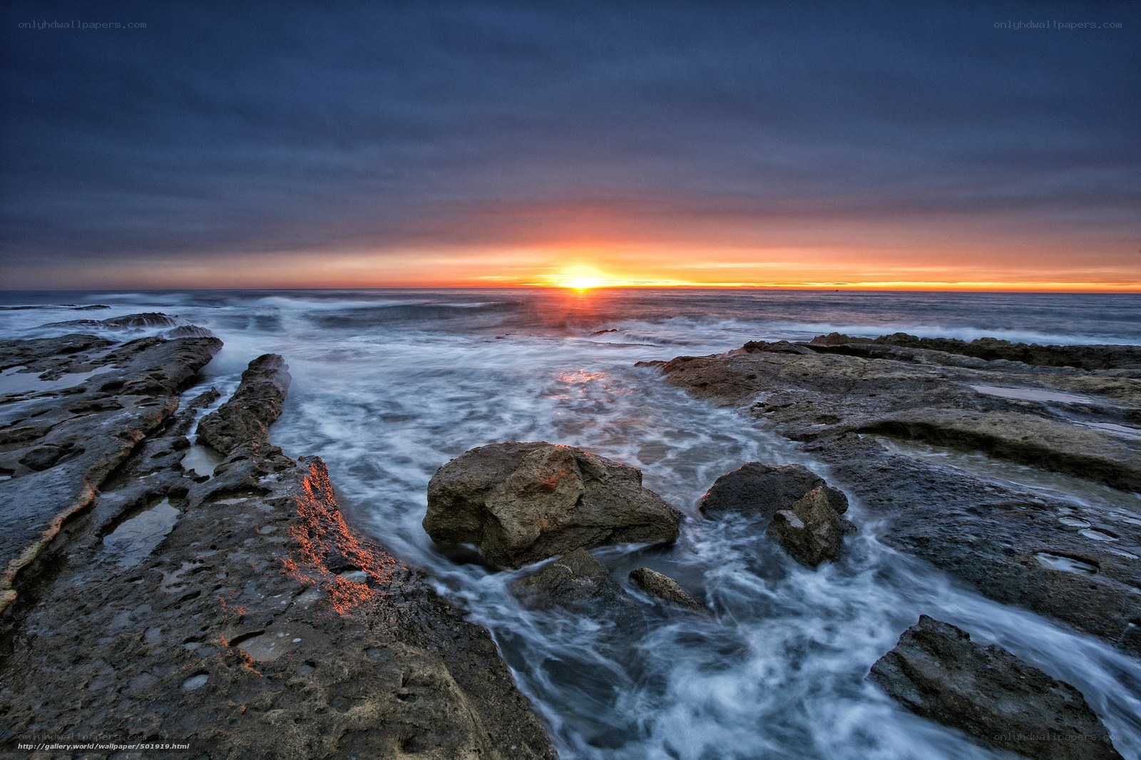 Sunset over rocky coastline