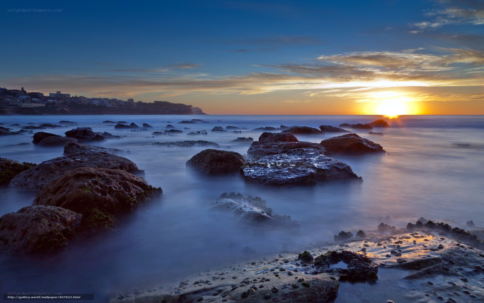 Sunset over rocky coastline