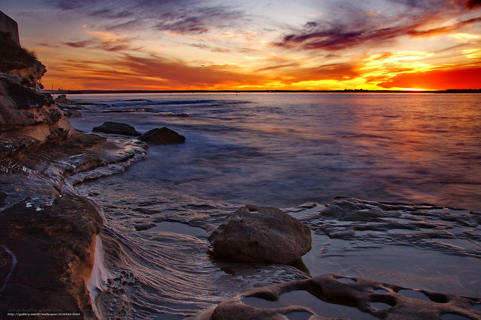 Sunset over rocky coastline