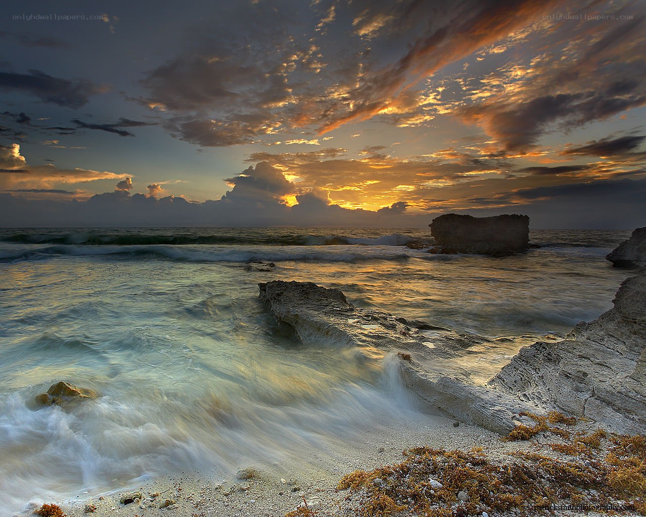 Sunset over rocky coastline