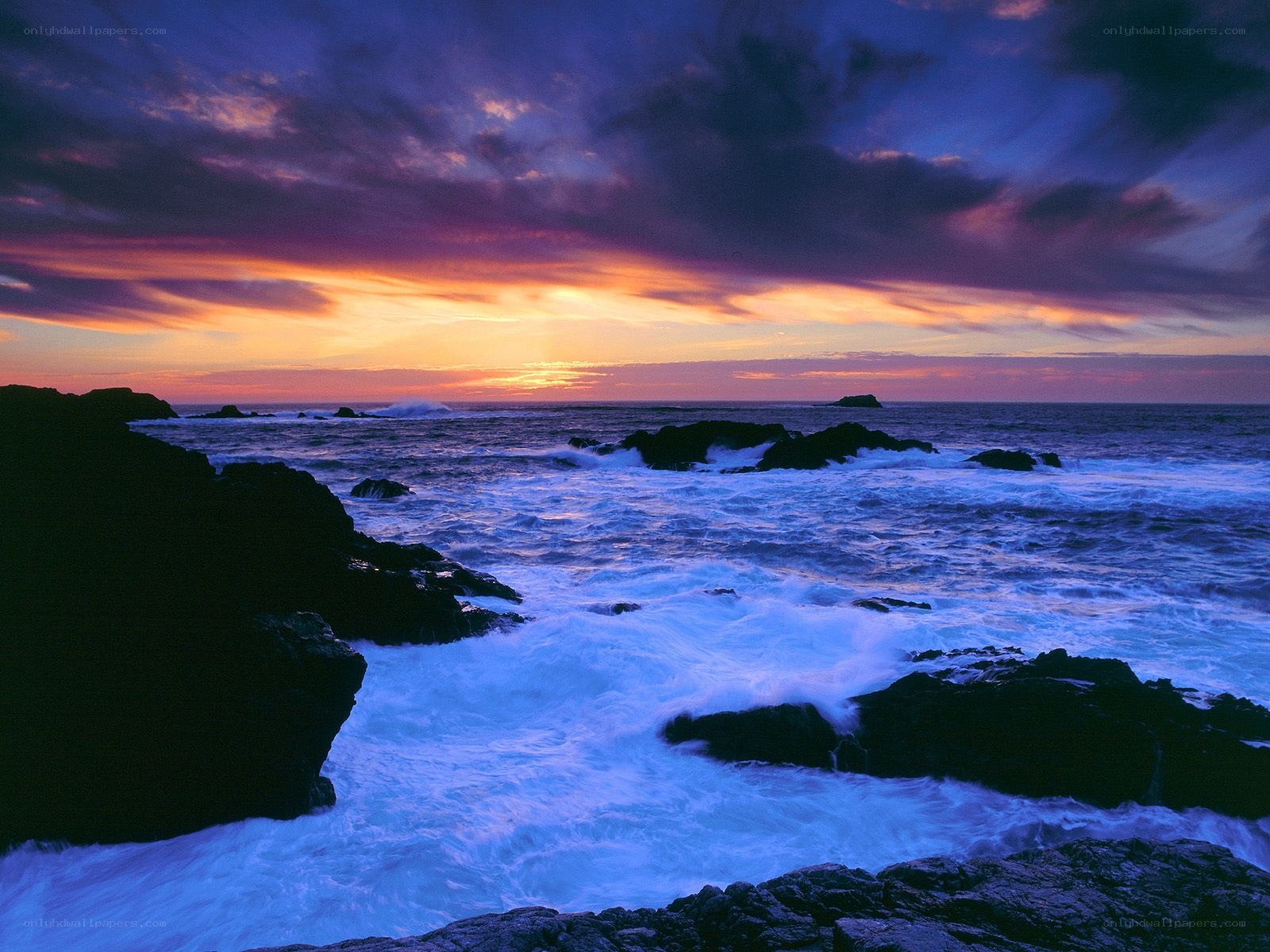 Sunset over rocky coastline