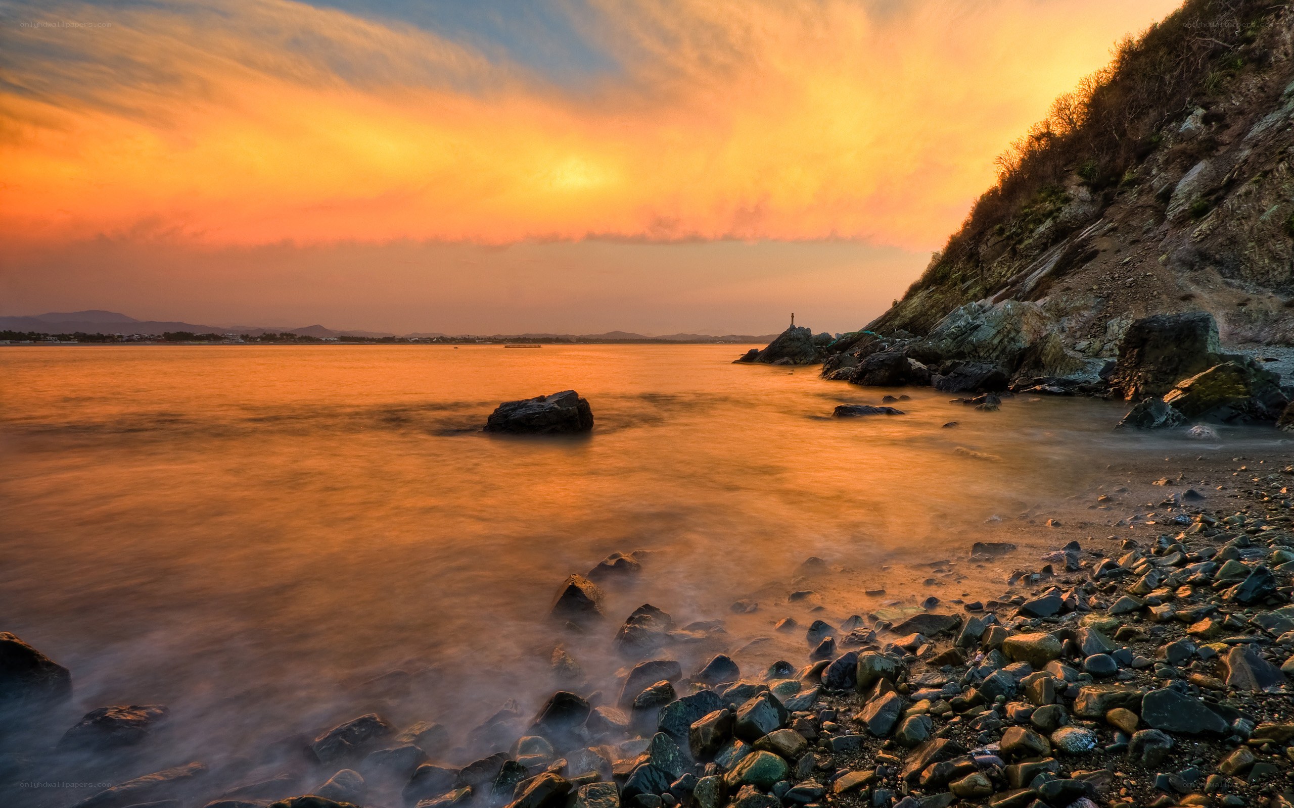Sunset over rocky coastline