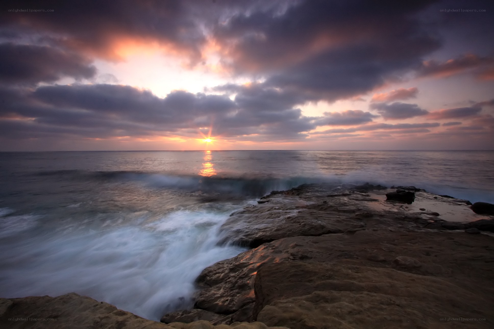 Sunset over rocky coastline