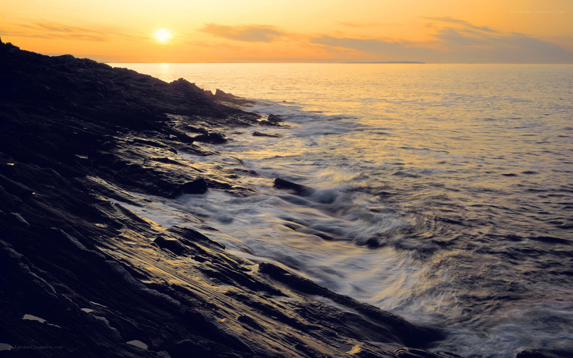 Sunset over rocky coastline