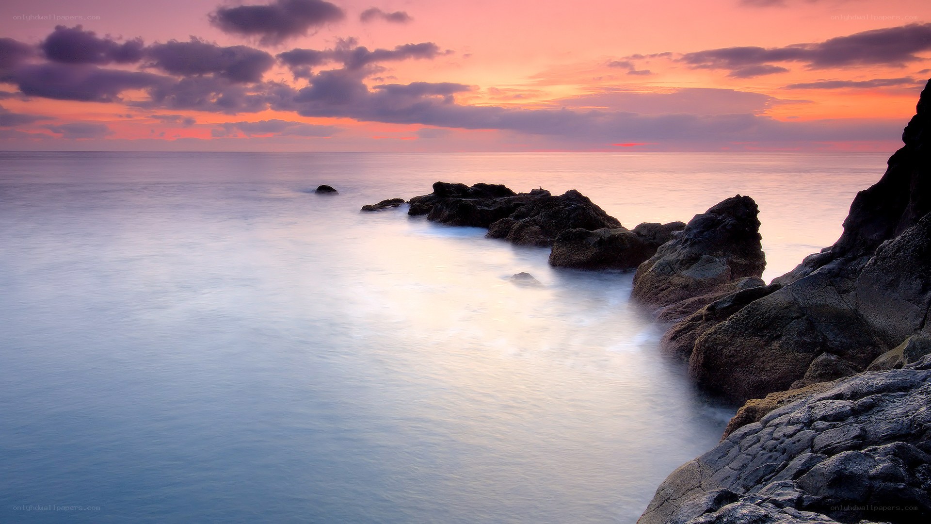 Sunset over rocky coastline
