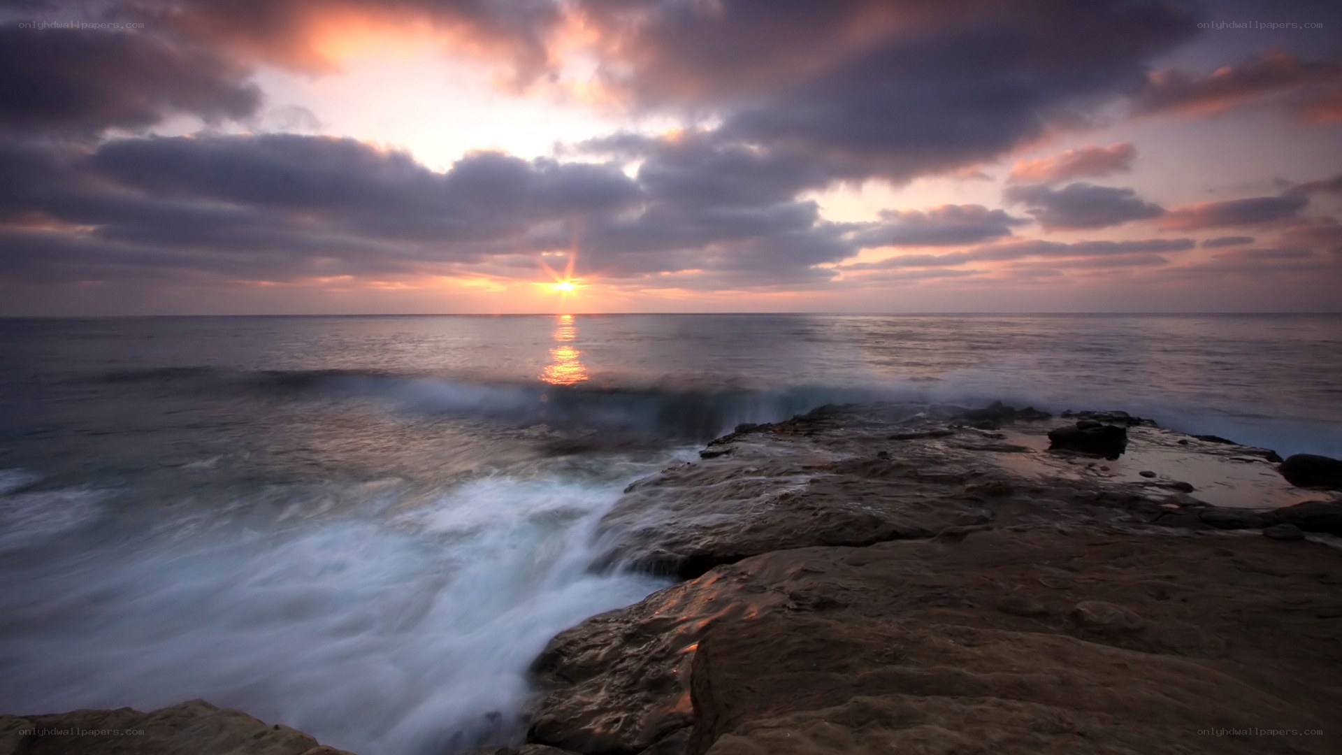 Sunset over rocky coastline