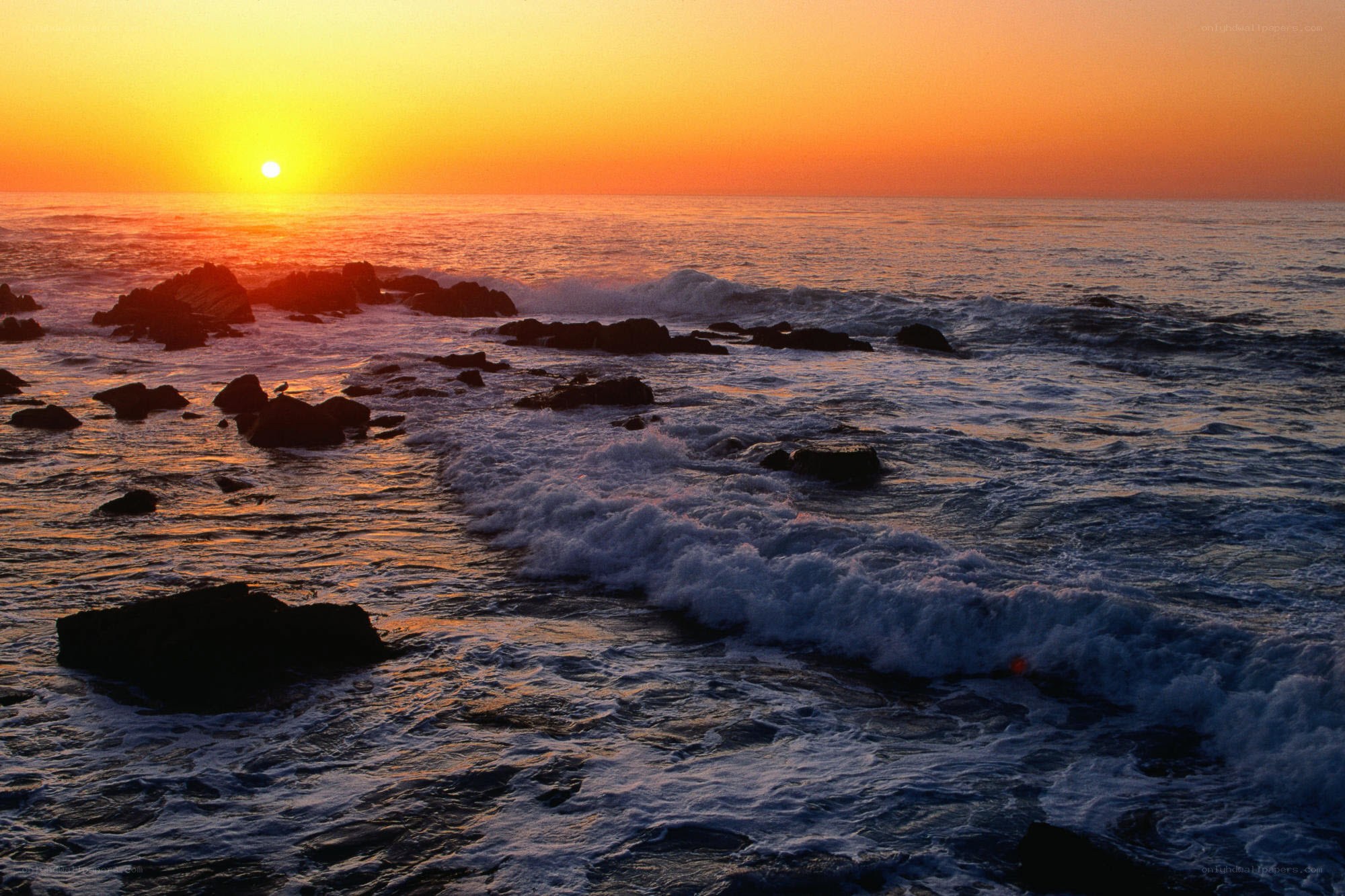 Sunset over rocky coastline