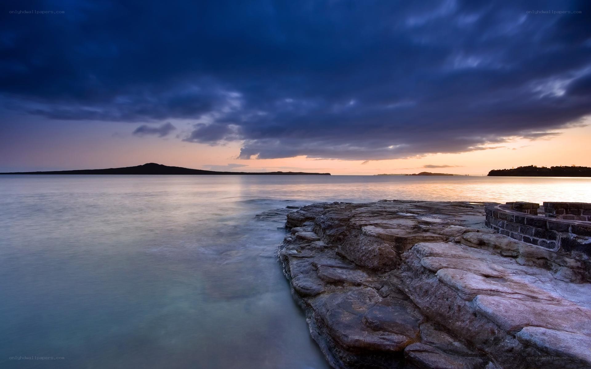 Sunset over rocky coastline