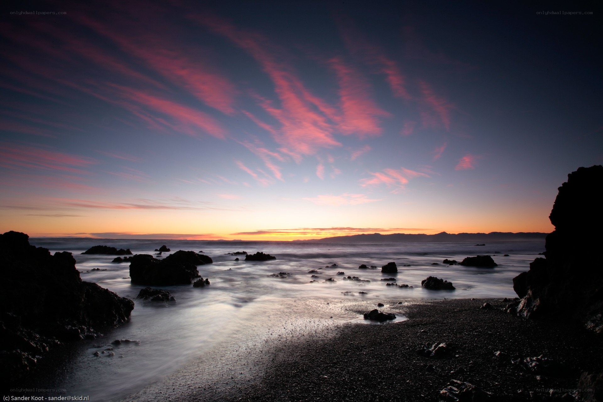 Sunset over rocky coastline