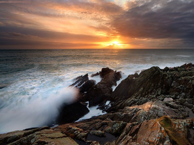 Sunset over rocky coastline