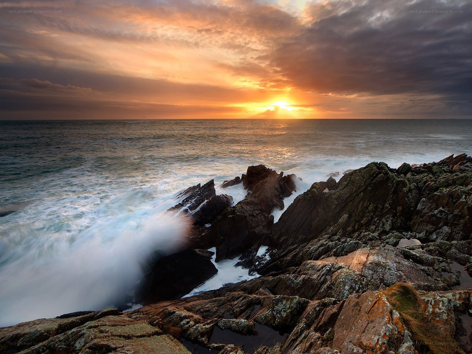 Sunset over rocky coastline