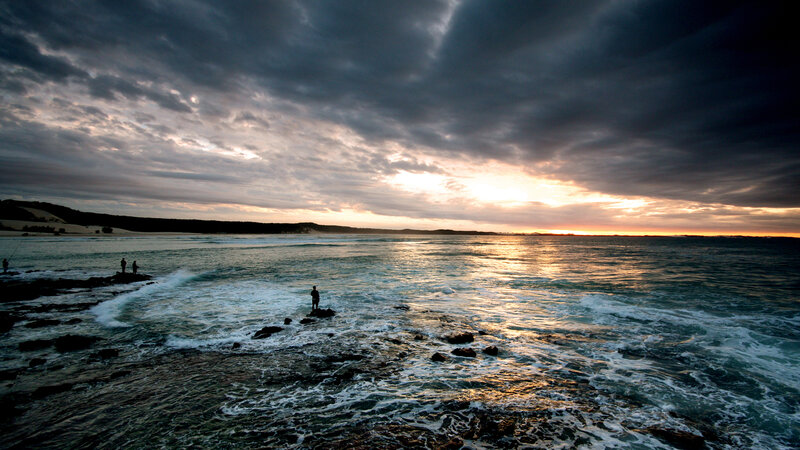 Sunset over rocky coastline