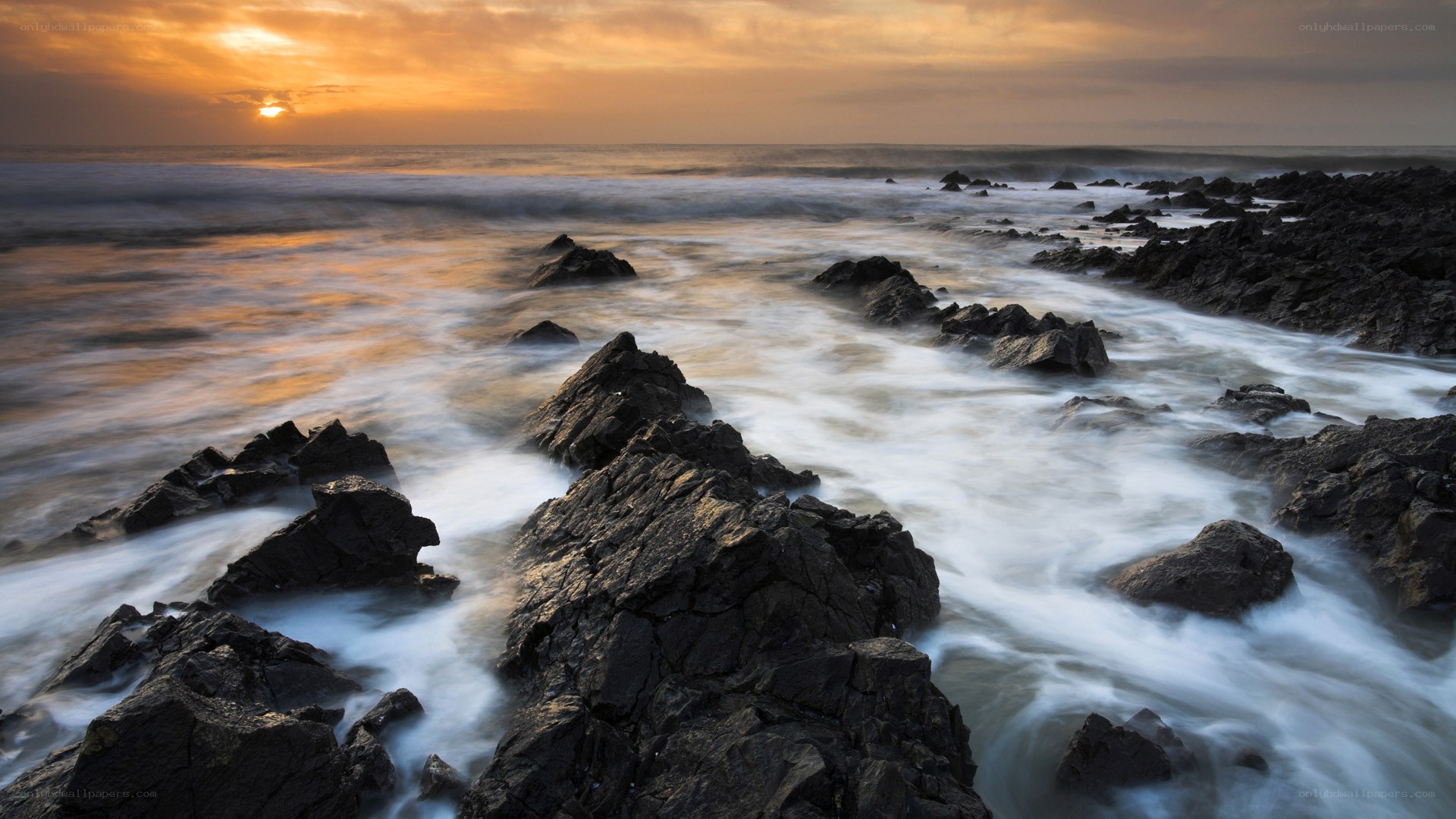 Sunset over rocky coastline