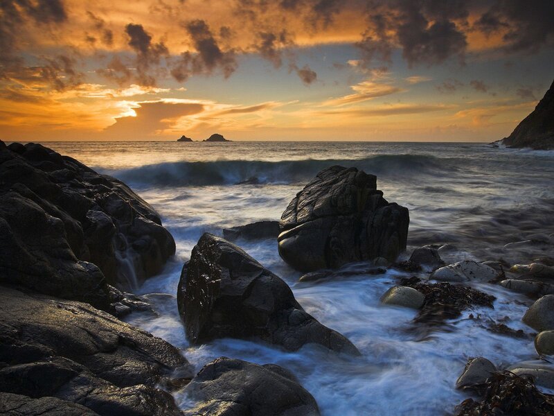 Sunset over rocky coastline