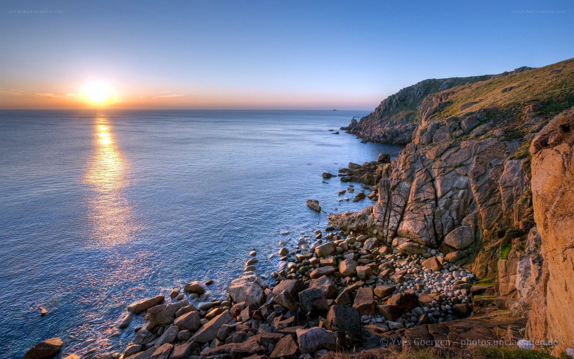 Sunset over rocky coastline