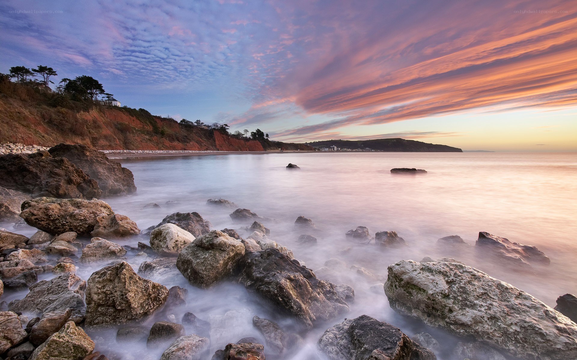 Sunset over rocky coastline