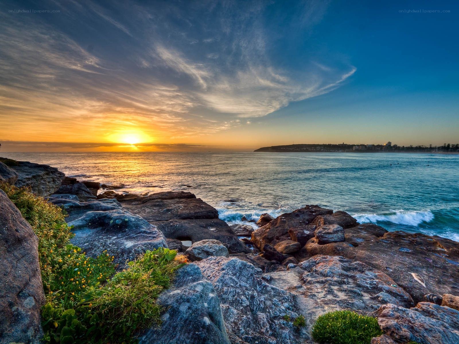 Sunset over rocky coastline