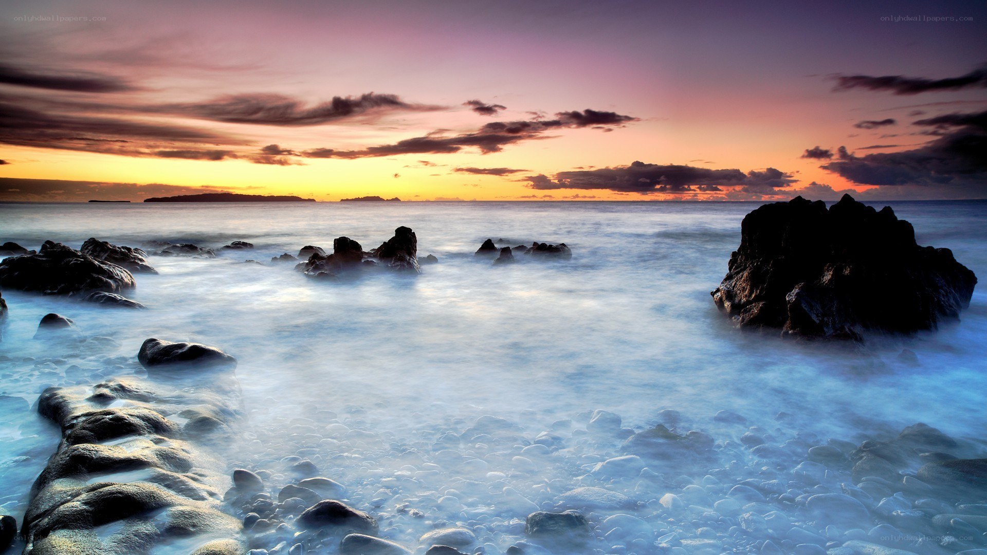 Sunset over rocky coastline
