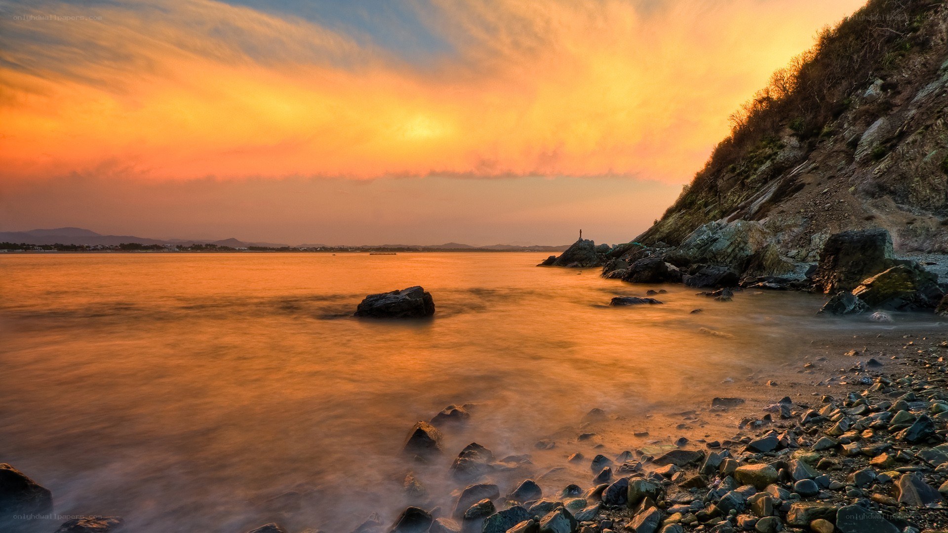 Sunset over rocky coastline