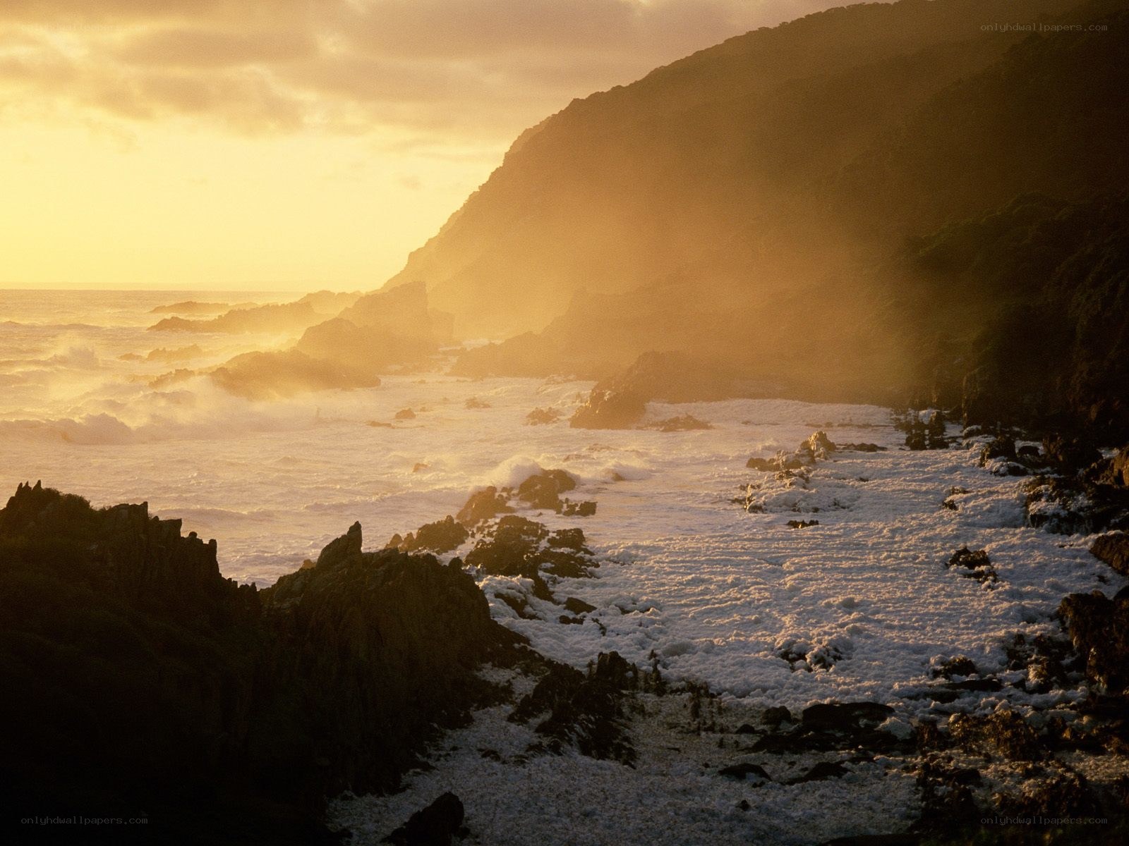 Sunset over rocky coastline