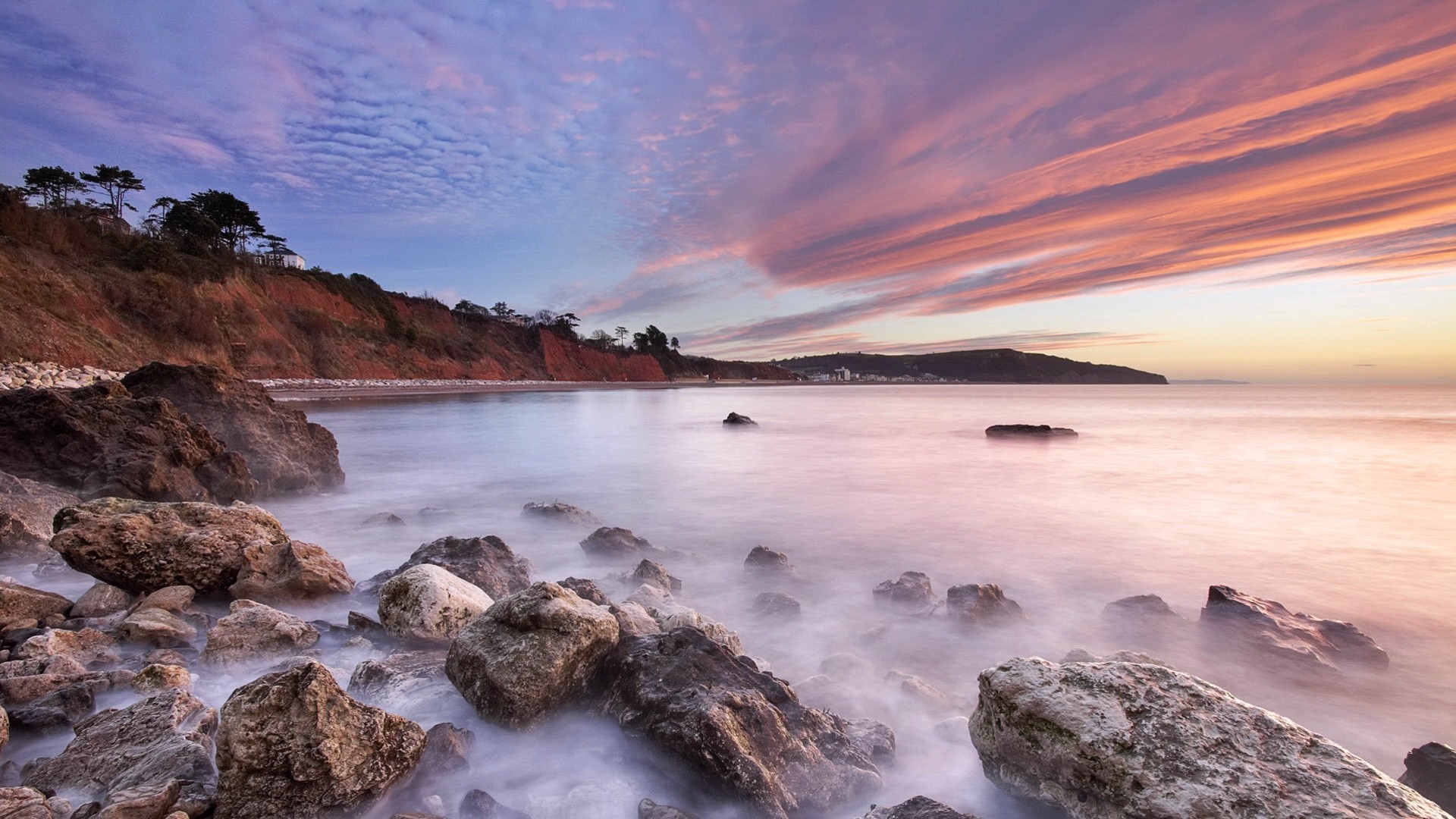Sunset over rocky coastline