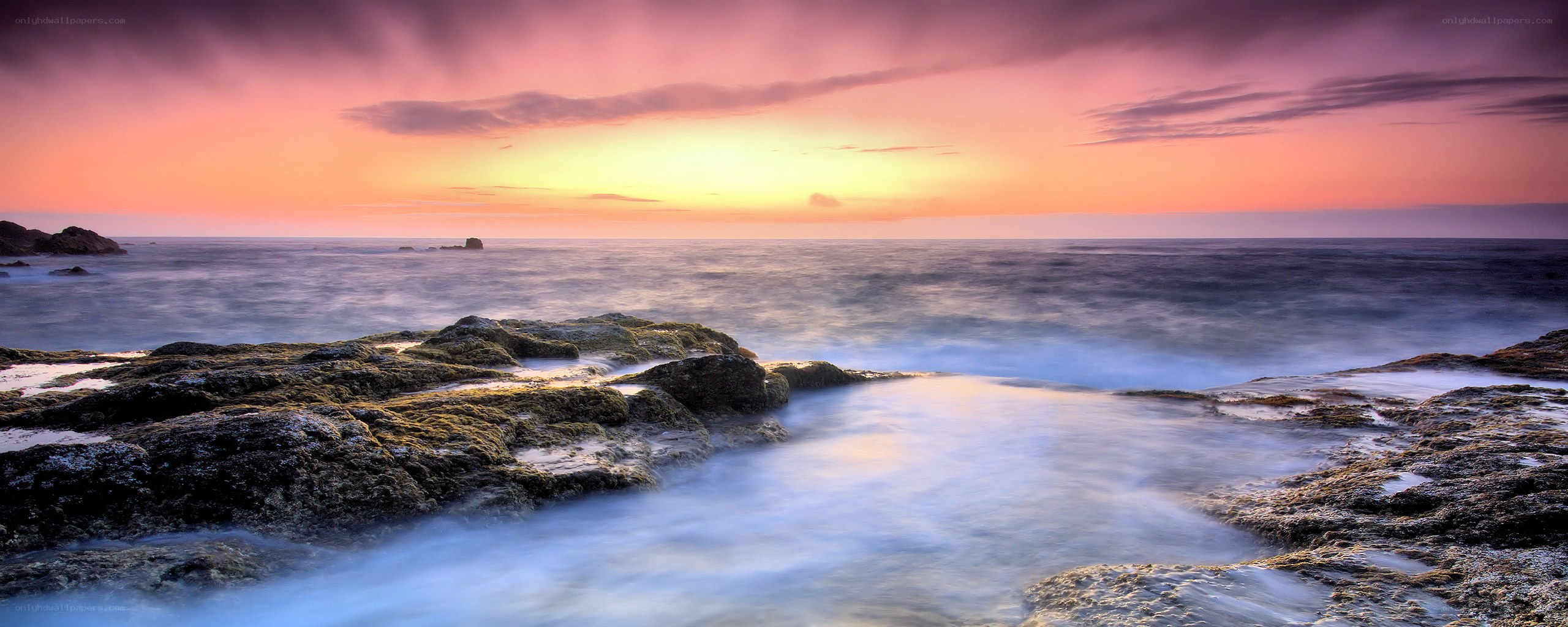 Sunset over rocky coastline
