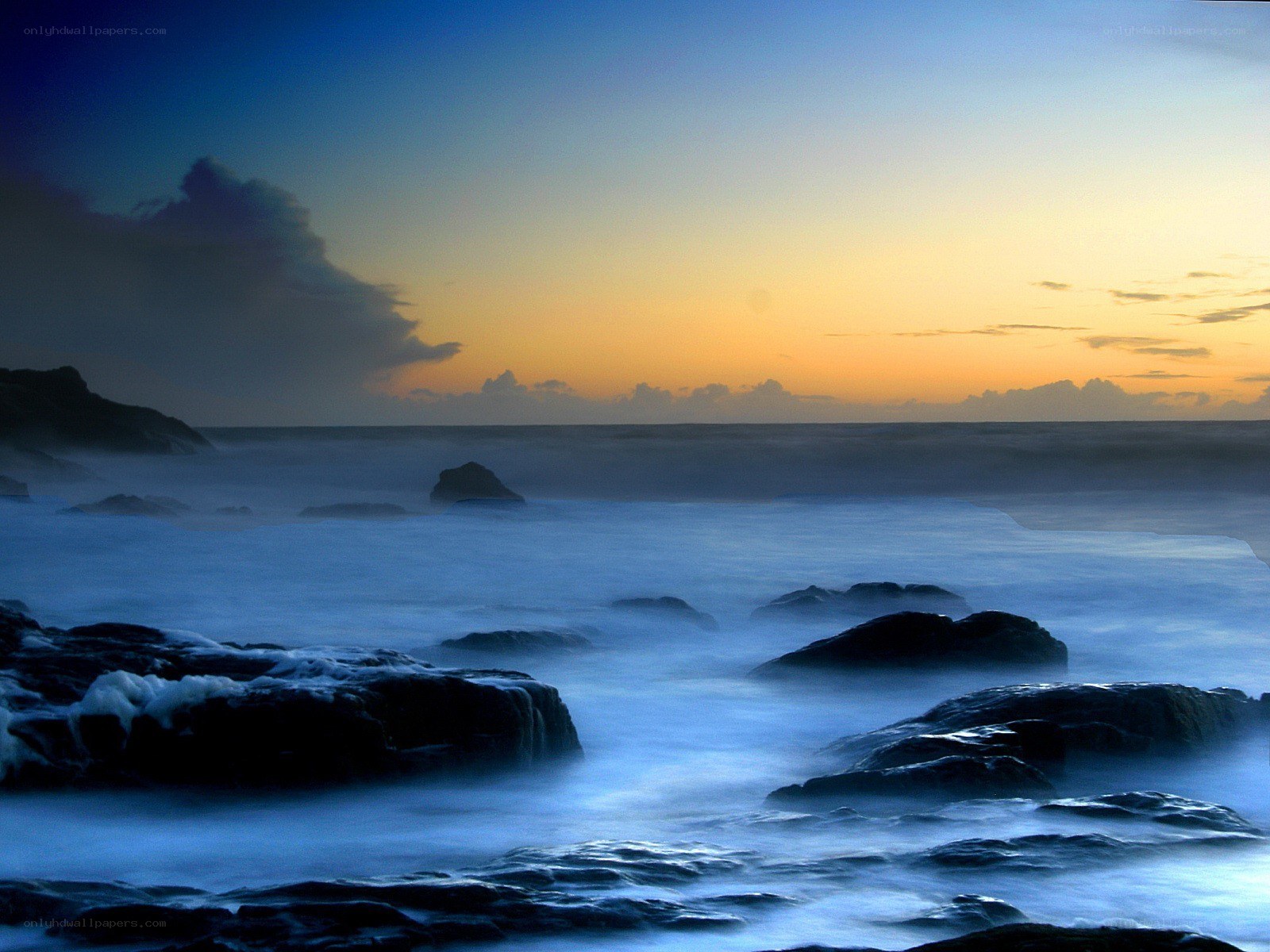 Sunset over rocky coastline