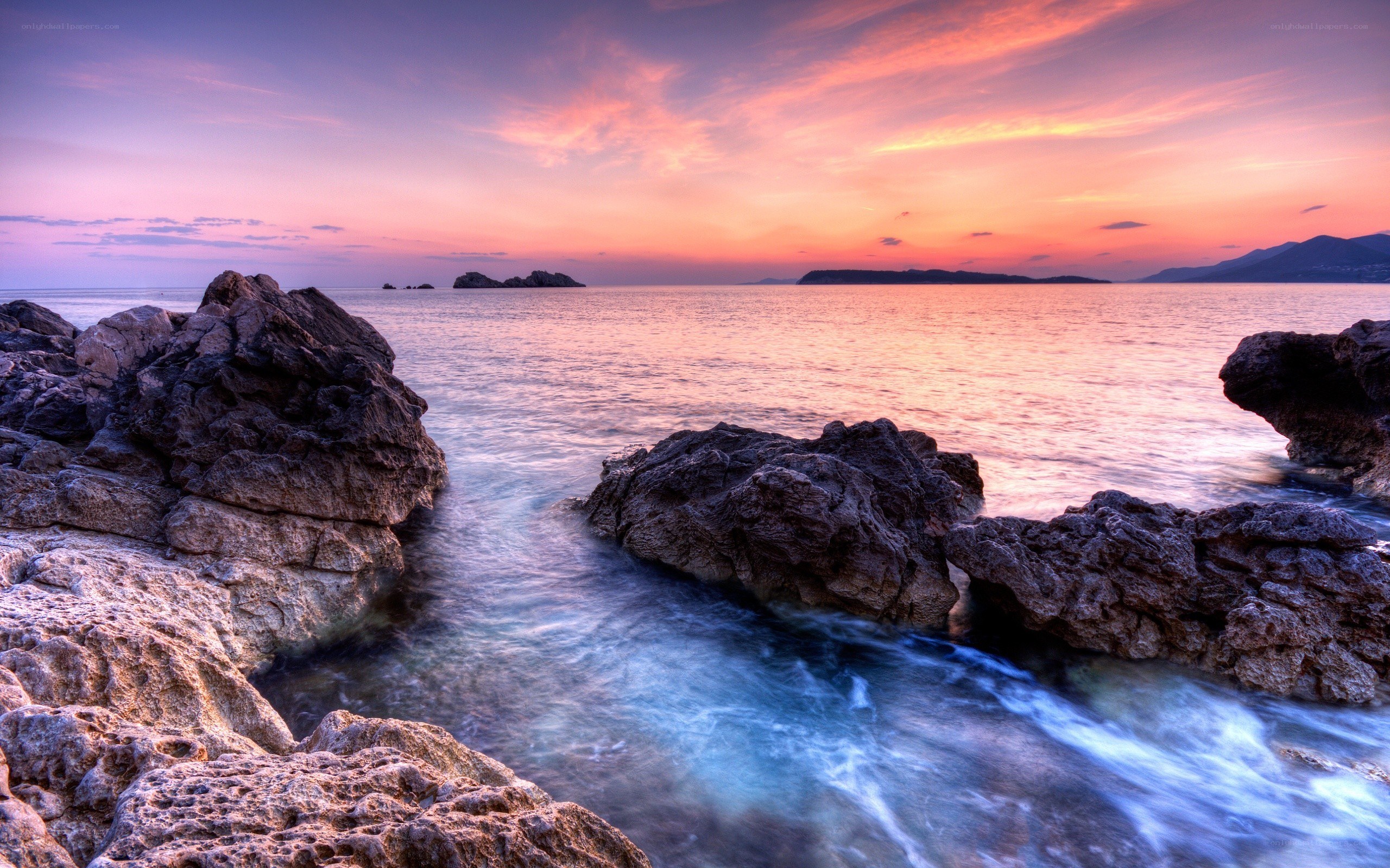 Sunset over rocky coastline