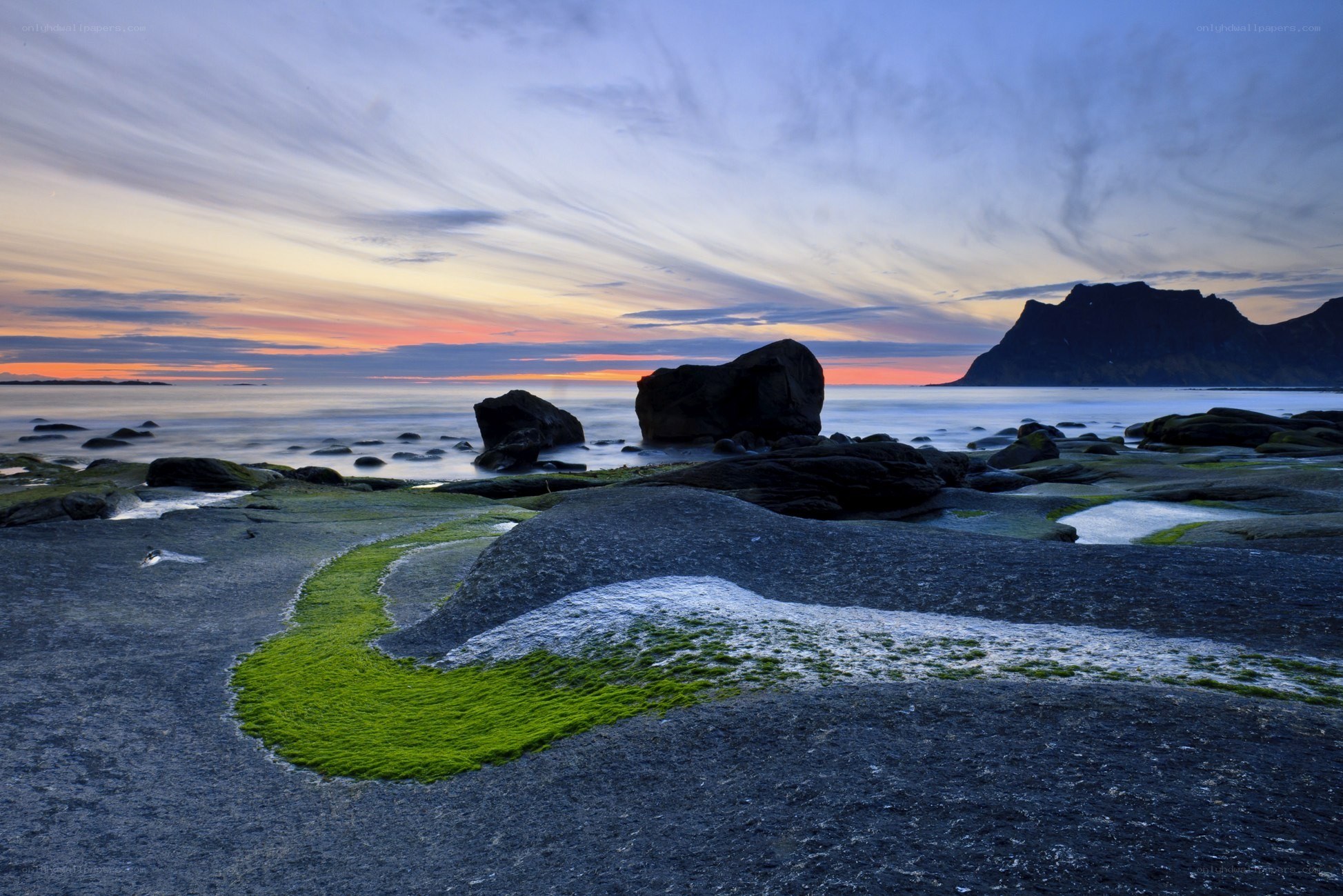 Sunset over rocky coastline
