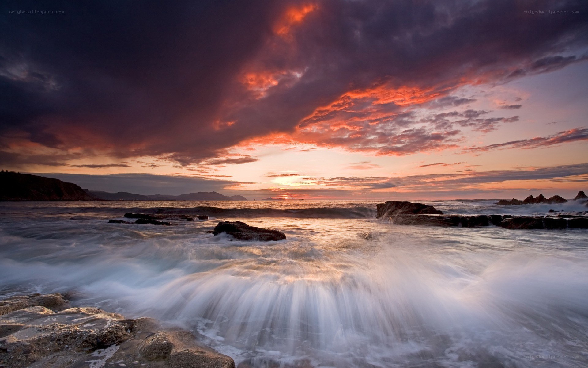 Sunset over rocky coastline