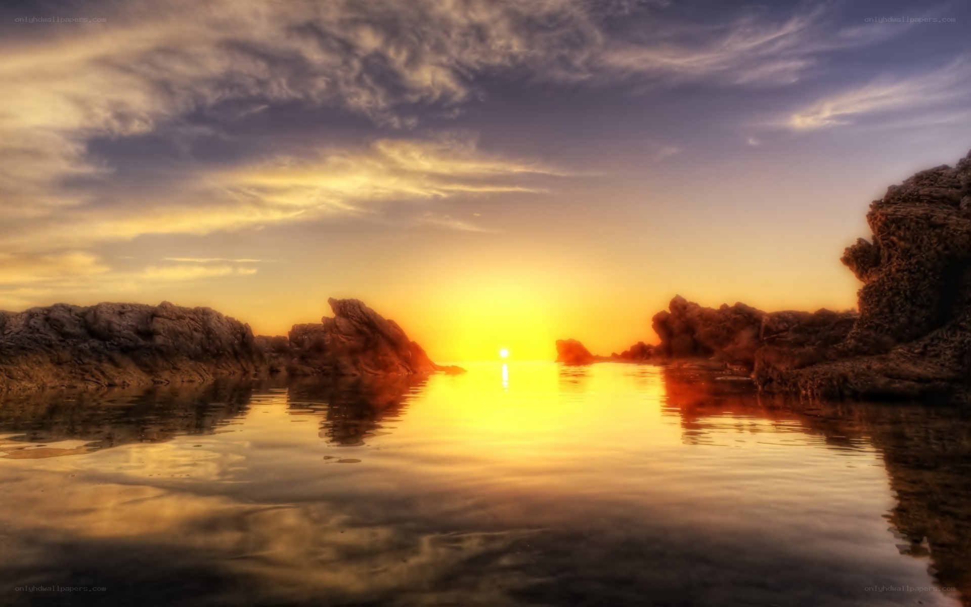 Sunset over rocky coastline