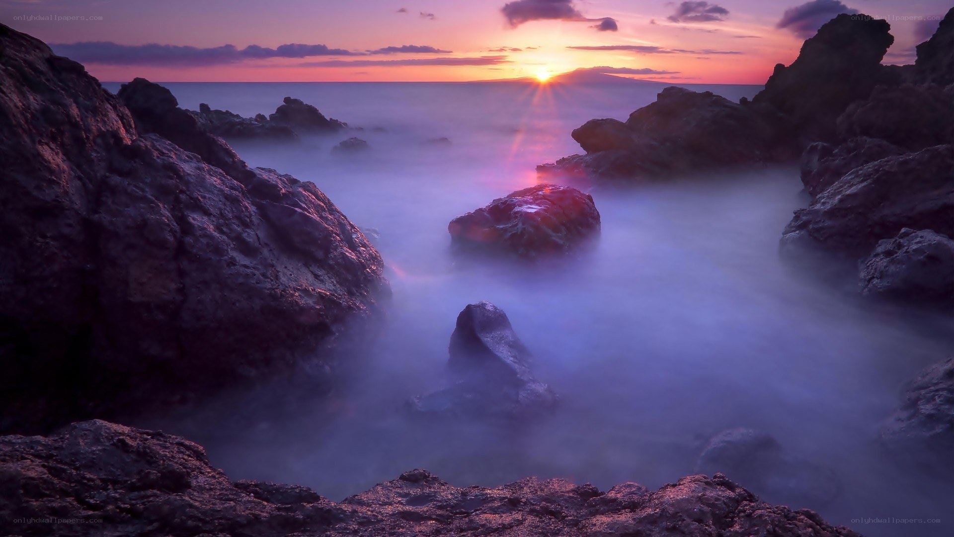 Sunset over rocky coastline