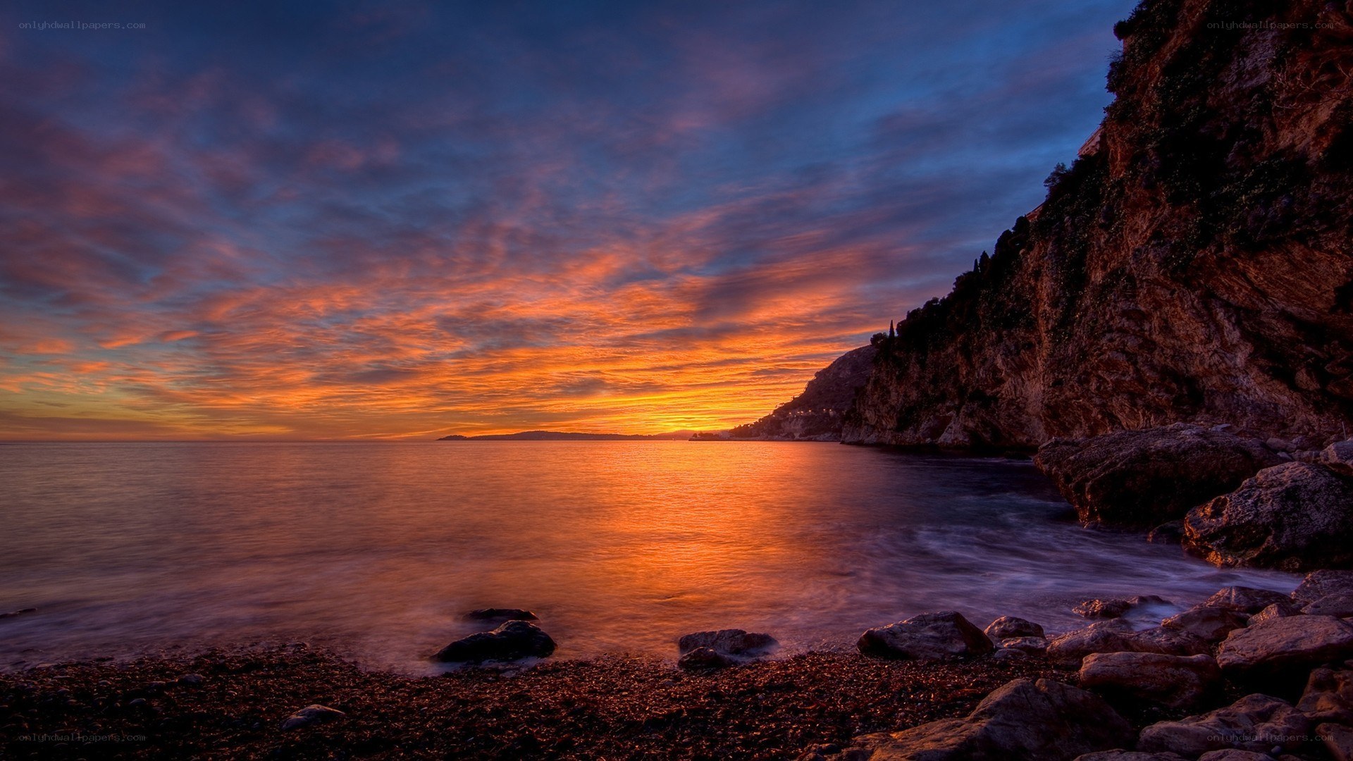 Sunset over rocky coastline