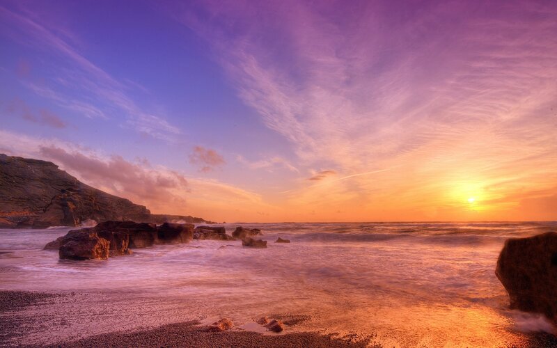 Sunset over rocky coastline