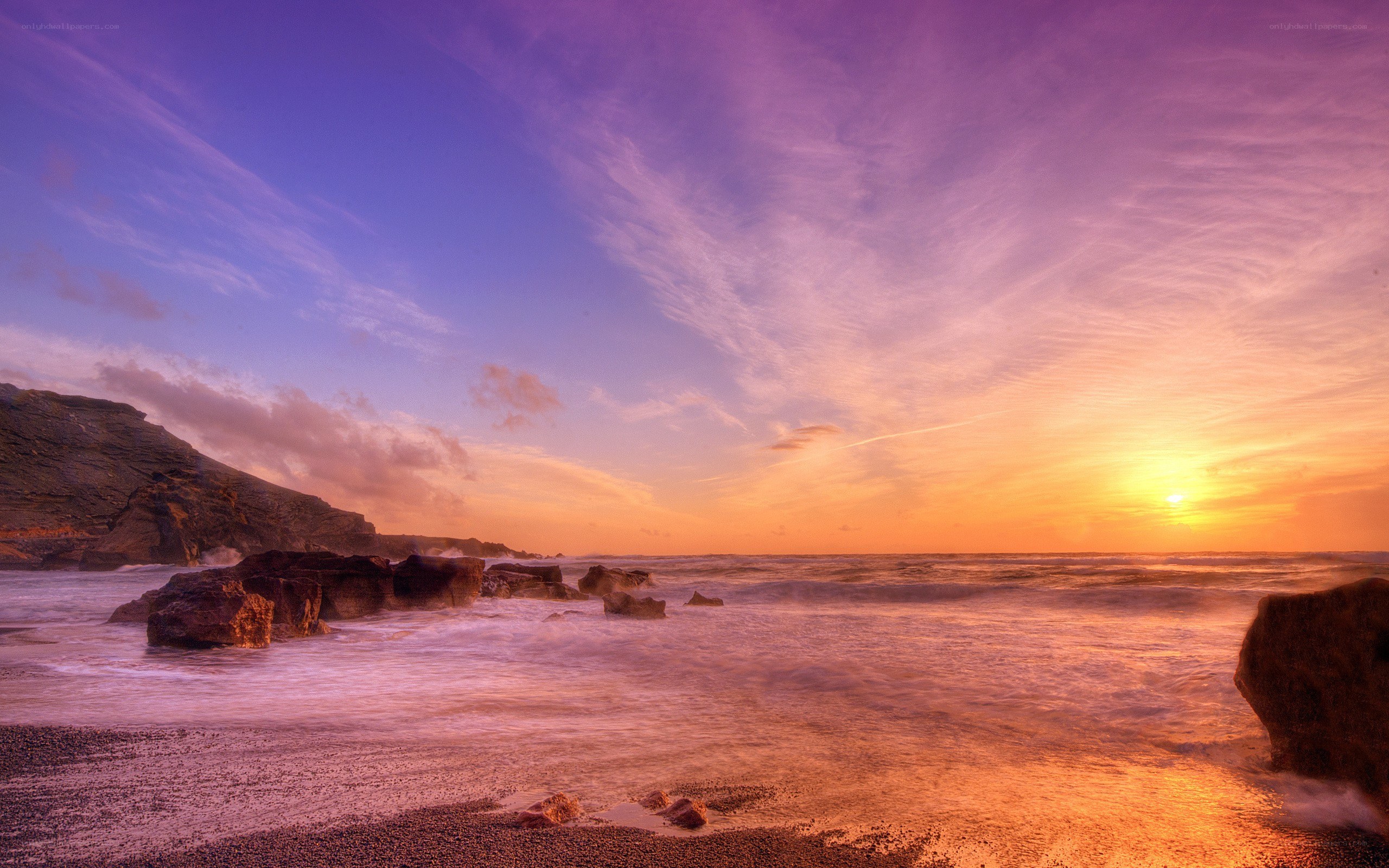 Sunset over rocky coastline