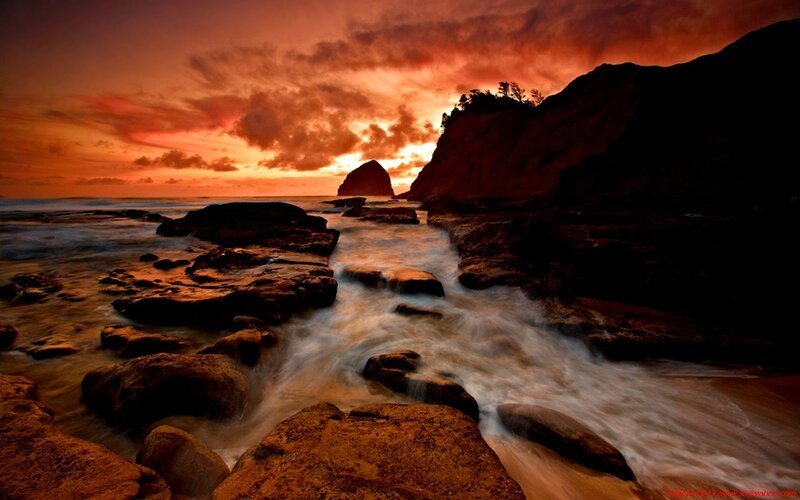 Sunset over rocky coastline