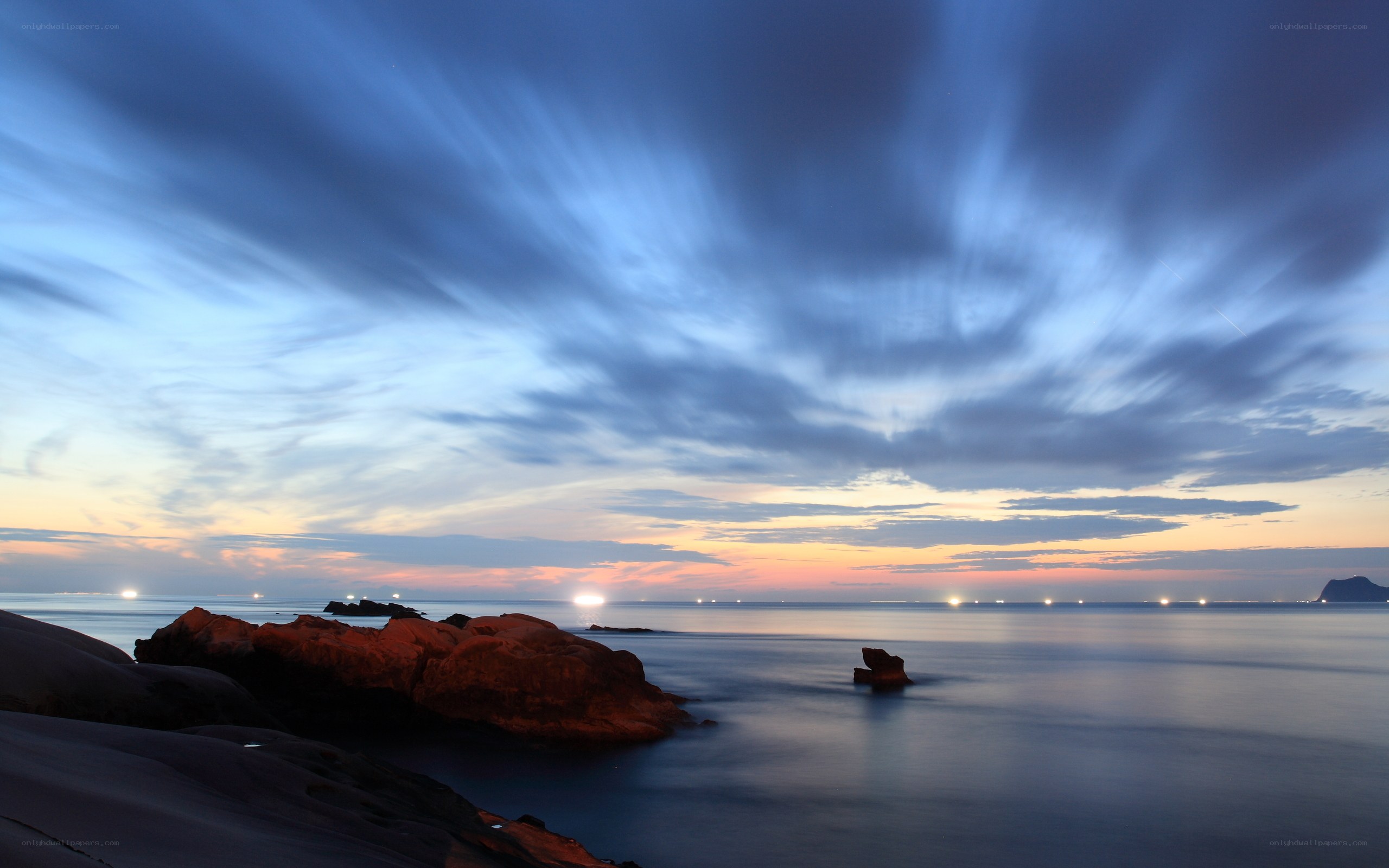 Sunset over rocky coastline