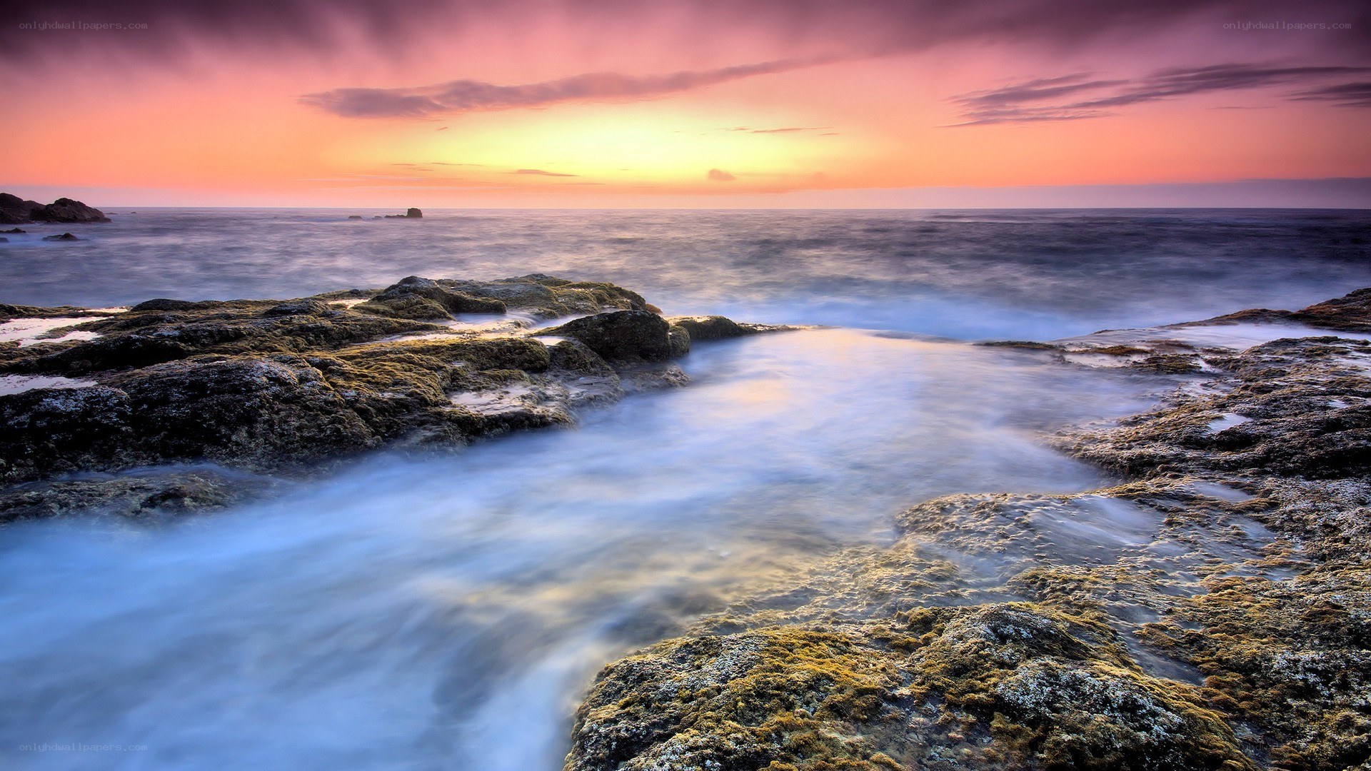 Sunset over rocky coastline