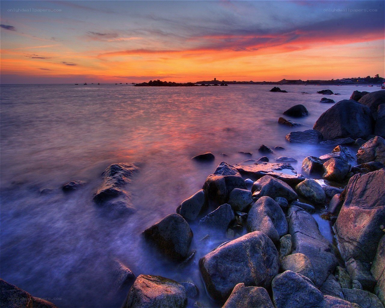 Sunset over rocky coastline