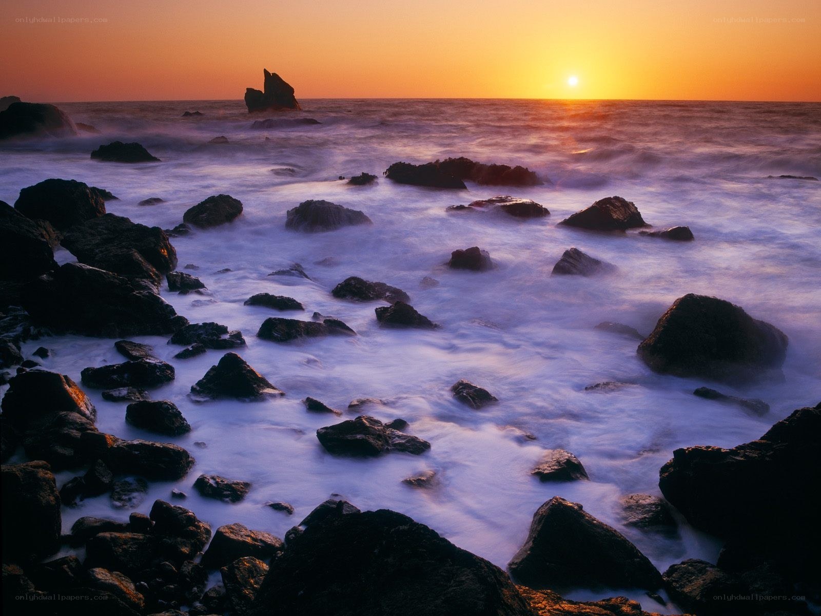 Sunset over rocky coastline