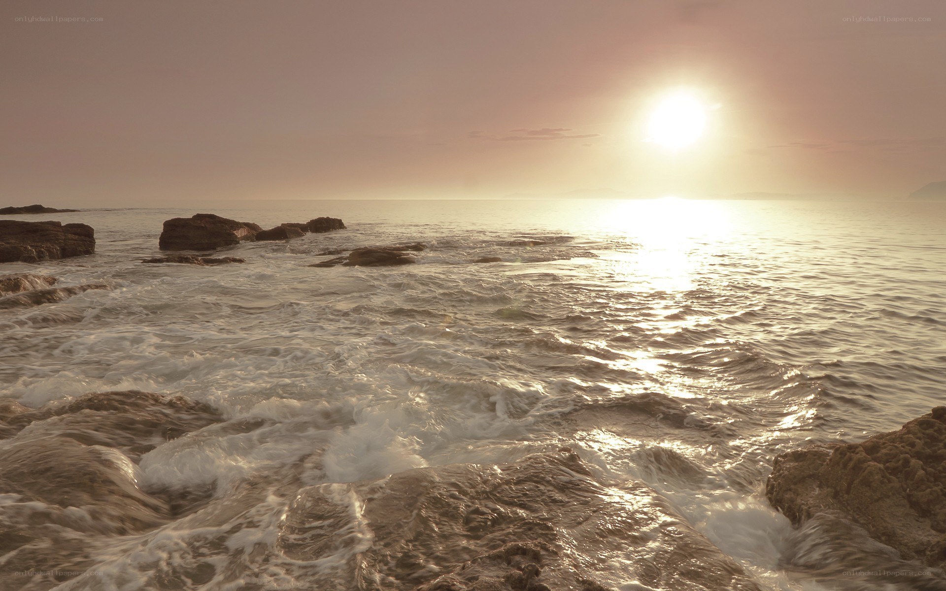 Sunset over rocky coastline