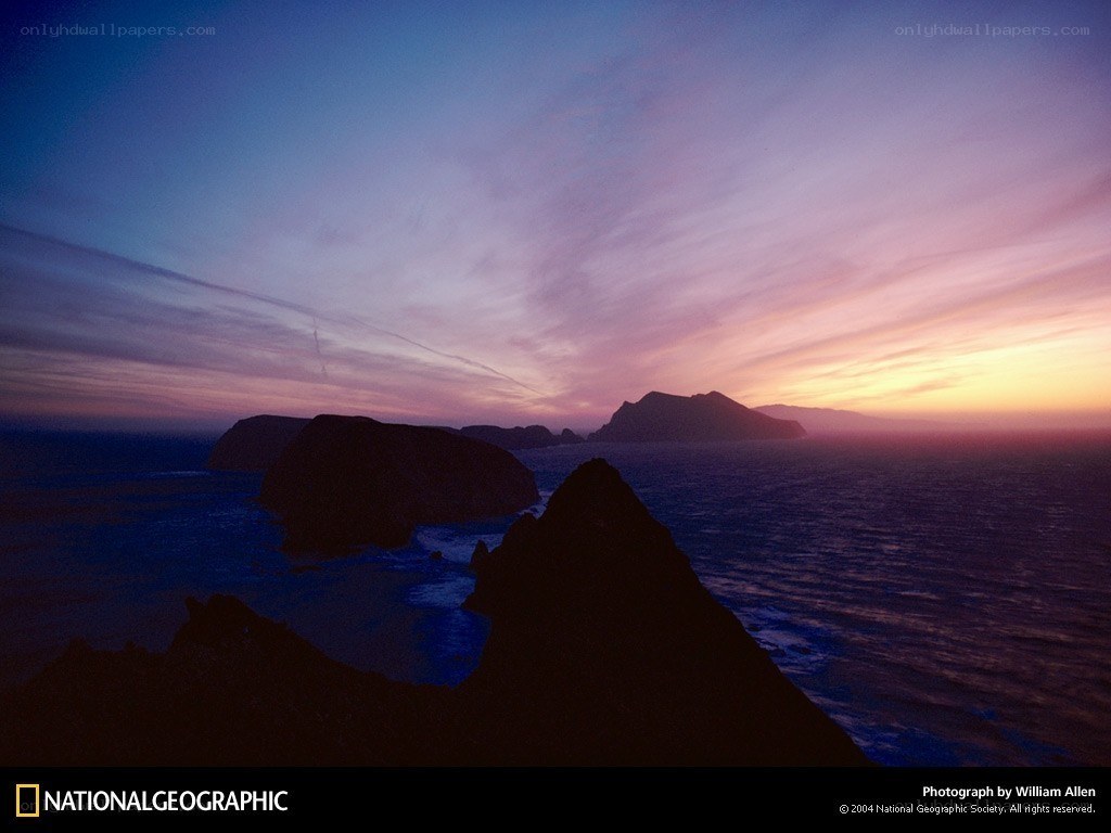 Sunset over rocky coastline